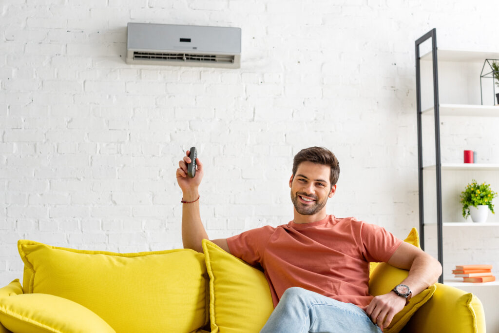 Man-sitting-under-AC