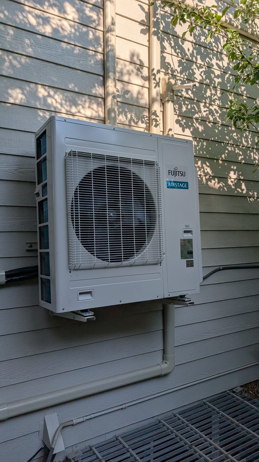 Fujitsu outdoor heat pump condenser installed on a Denver home