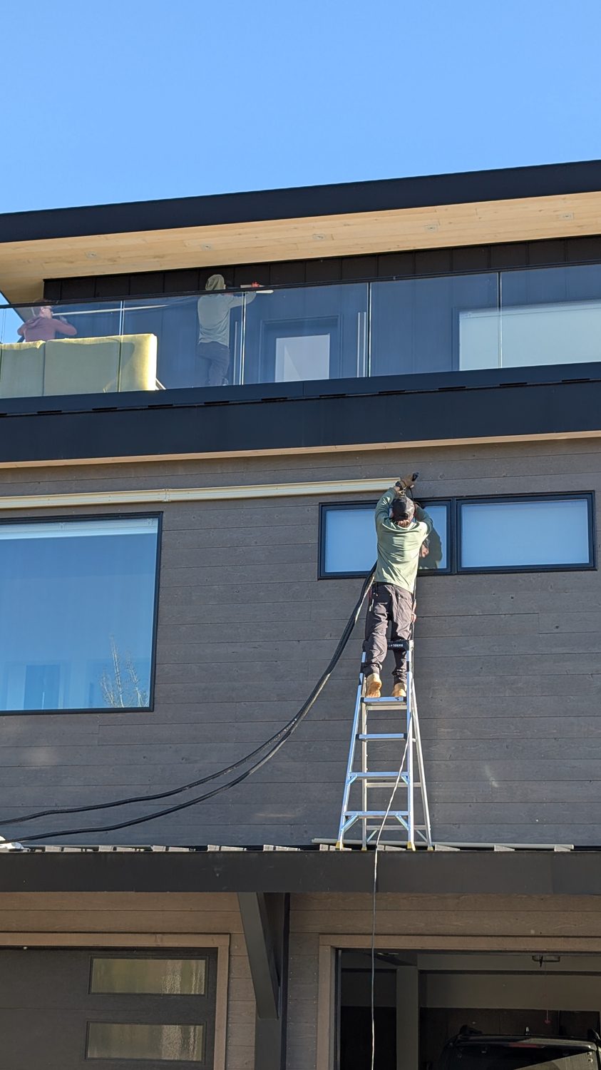 Technician installing a mini-split on a modern Colorado home