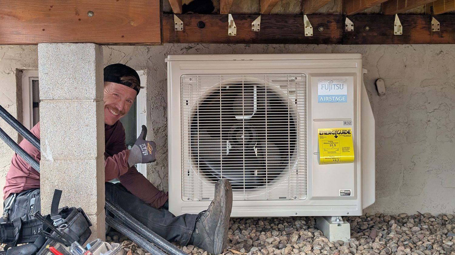 Technician installing an outdoor mini-split condenser in Denver